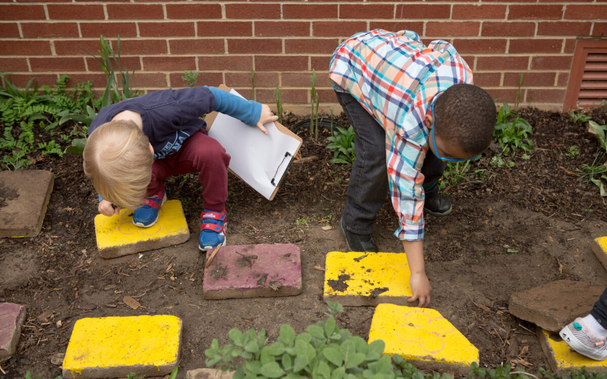 Two preschool boys in garden